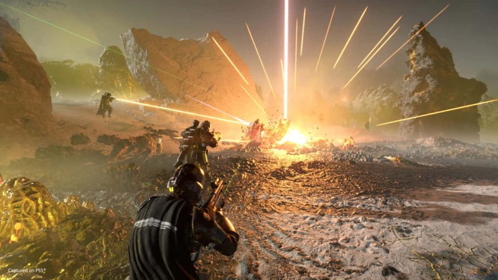 Helldivers 2 battle scene with armored soldiers fighting on alien planet amid bright explosion wallpaper