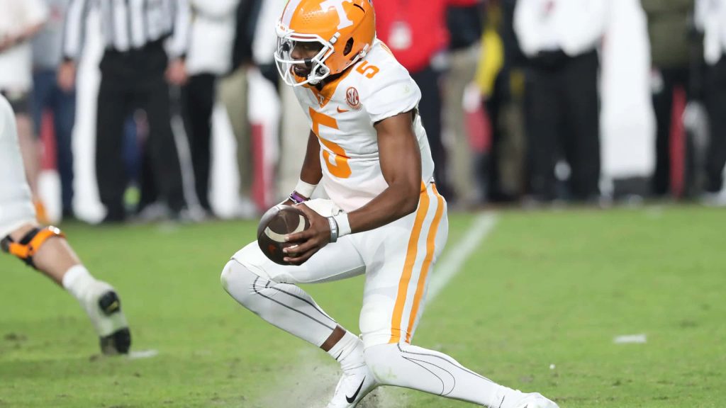 Hendon Hooker in white and orange Tennessee uniform crouched on field action wallpaper background