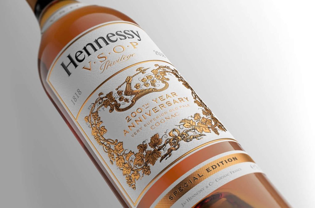 Close-up of Hennessy V S O P Privilège 200th Anniversary bottle with gold label and amber cognac Wallpaper