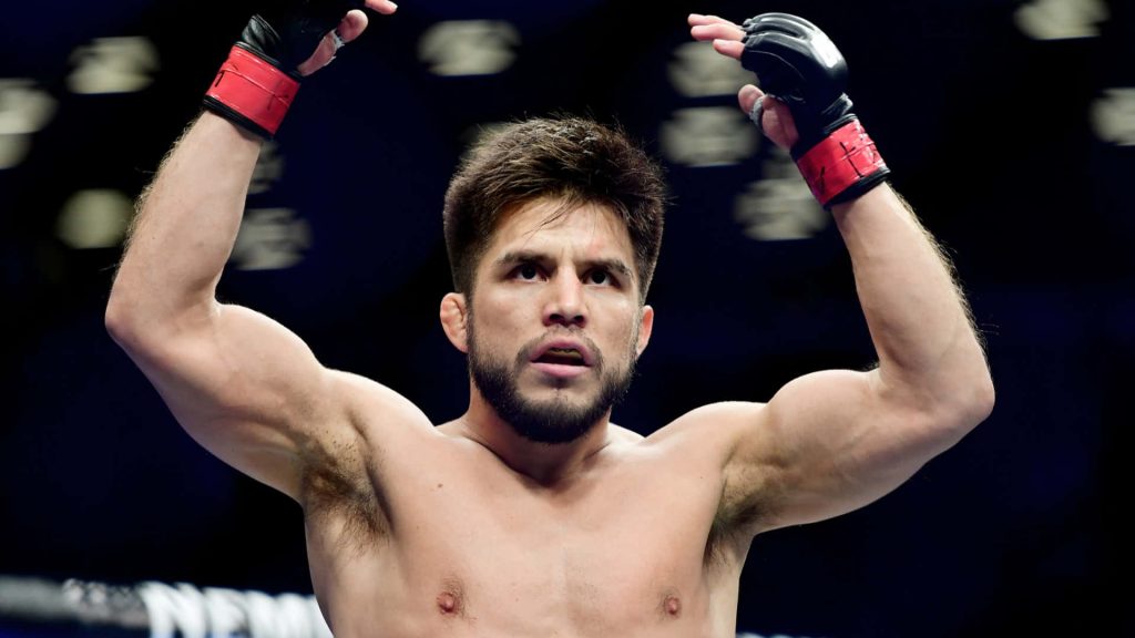 Henry Cejudo UFC champion with raised arms in victory dynamic MMA wallpaper background