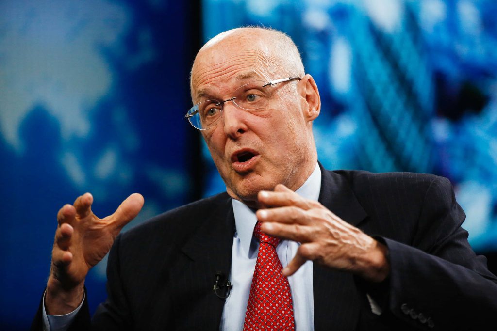 Portrait of Henry M Paulson in suit and red tie gesturing during financial TV interview background blurred Wallpaper