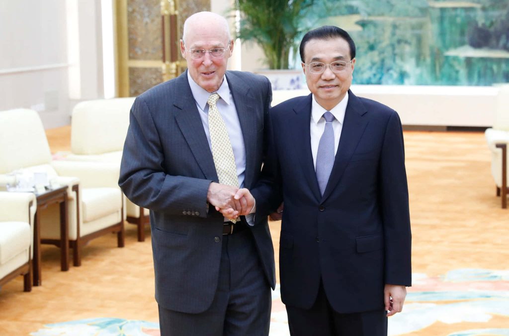 Henry M Paulson and late Premier Li Keqiang shake hands in formal diplomatic meeting room Wallpaper