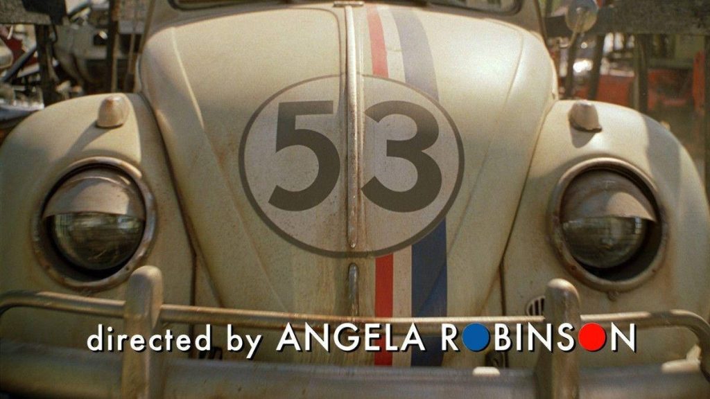 Close-up of Herbie Volkswagen Beetle cream car number 53 with racing stripes and director credit Wallpaper