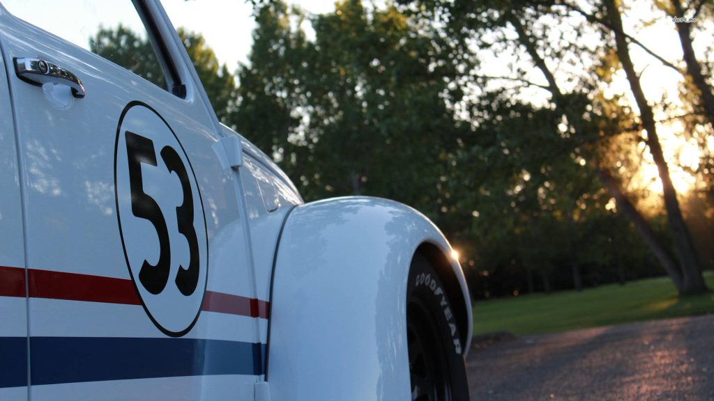 Close-up of Herbie Fully Loaded Volkswagen Beetle with number 53 and racing stripes at sunset Wallpaper
