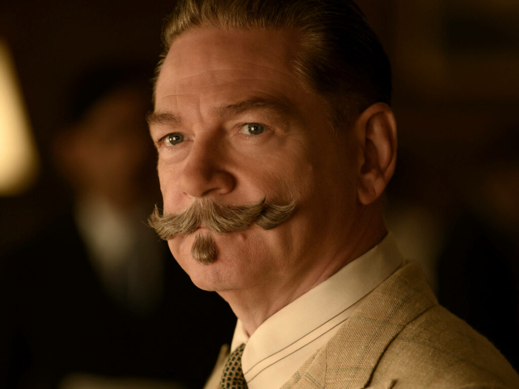 Close-up of Hercule Poirot with groomed mustache and thoughtful expression Death On The Nile wallpaper