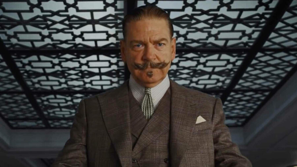 Hercule Poirot portrait in sharp suit with mustache against ornate patterned ceiling wallpaper