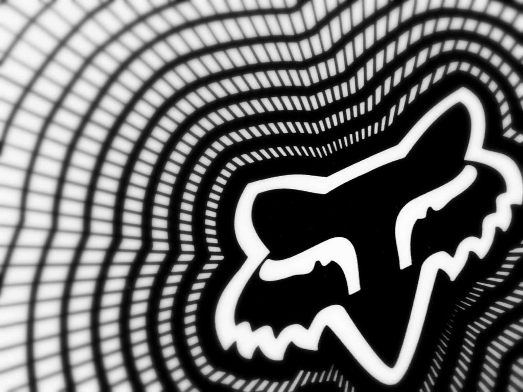 High-contrast black and white Fox Racing wallpaper with wavy grid and 3D Fox head logo design
