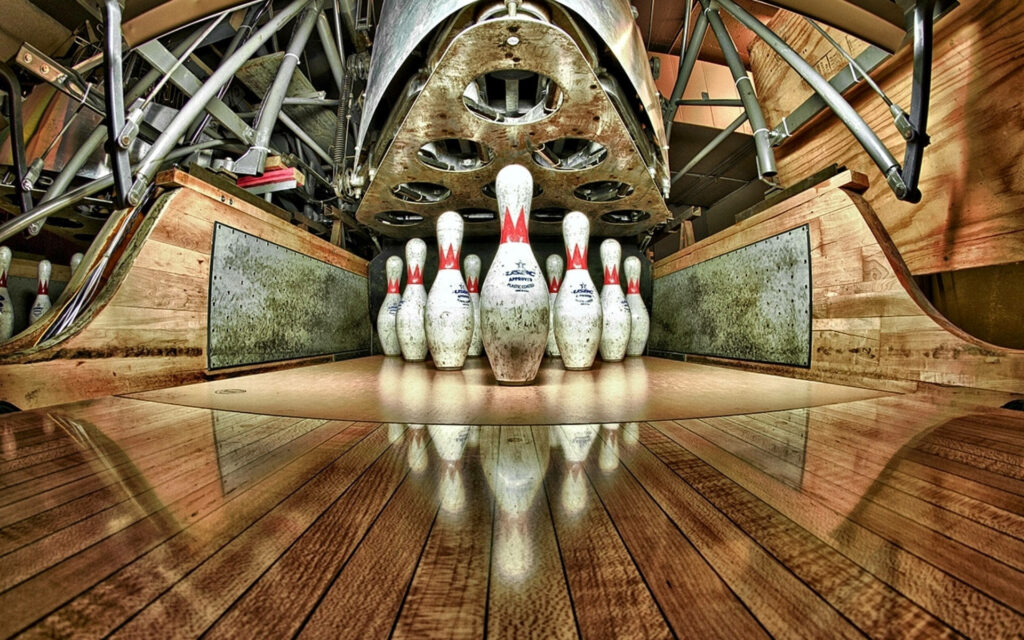 High contrast bowling duckpins on glossy wooden lane with industrial lighting and reflections wallpaper