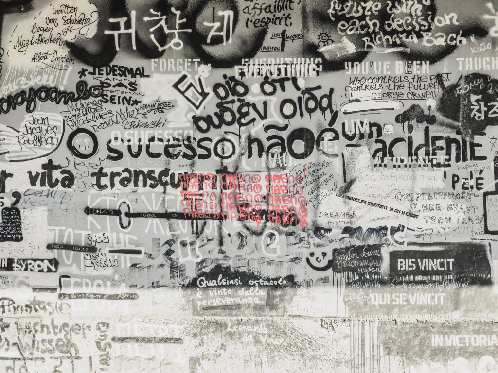High-contrast graffiti wallpaper with black white quotes from Orwell Einstein and red text highlight