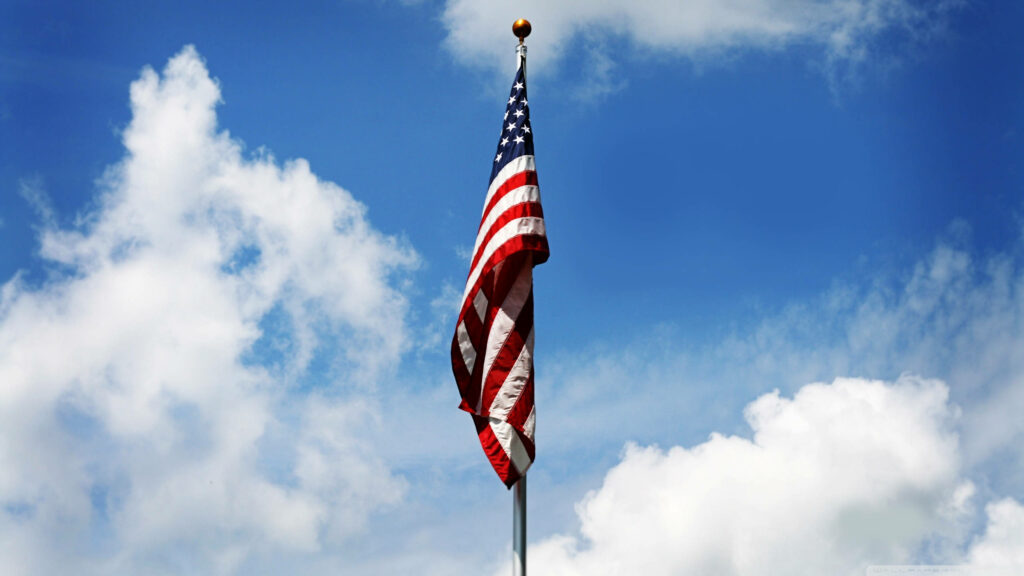 HD American Flag Wallpaper: Waving Against Blue Sky & Clouds