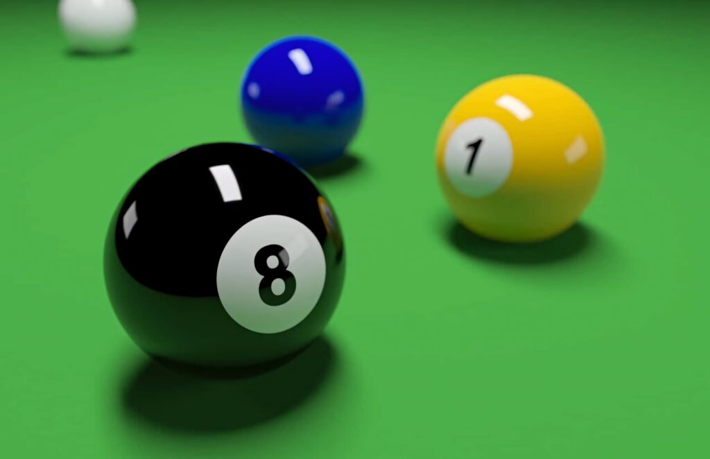 Close-up of glossy eight-ball on green billiards table with blurred blue and yellow balls background Wallpaper