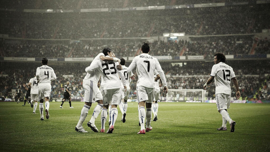 High-Definition Soccer Match Wallpaper: Players Celebrating Under Lights
