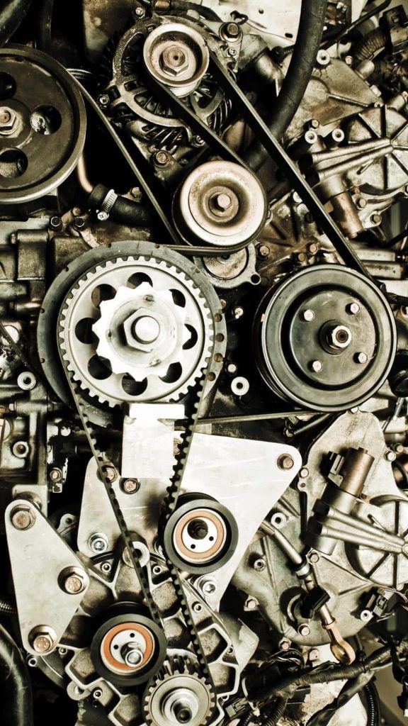 High-detail automotive engine gears pulleys rubber timing belts mechanical engineering wallpaper