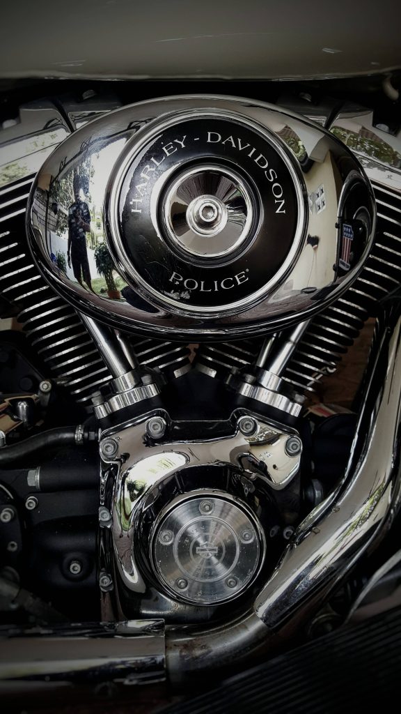 Close-up of polished Harley-Davidson Police V-twin engine with reflective chrome air cleaner cover Wallpaper