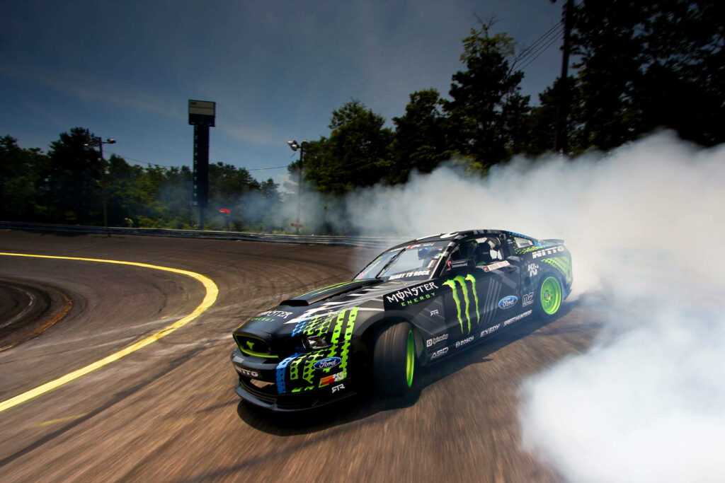 High-Intensity Ford Mustang Drifting Wallpaper with Monster Energy