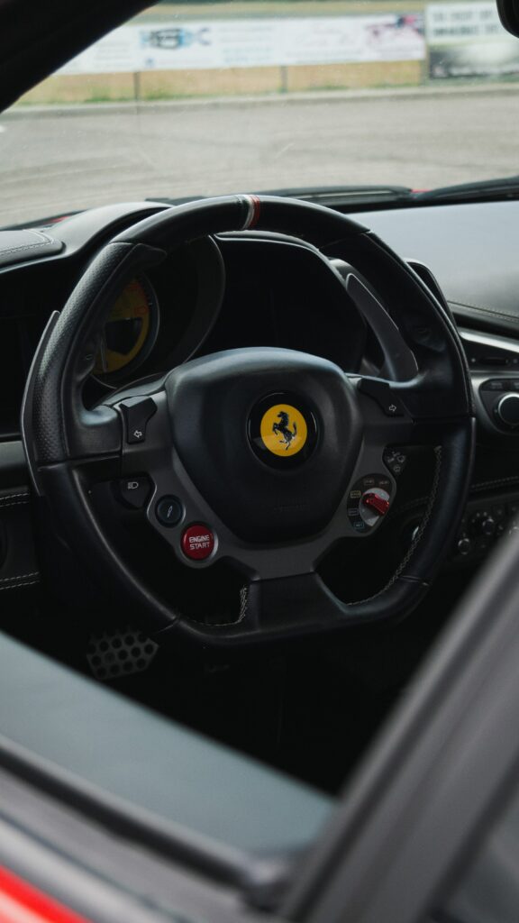High-Performance Car Interior: Sleek Steering Wheel & Luxurious Design Wallpaper