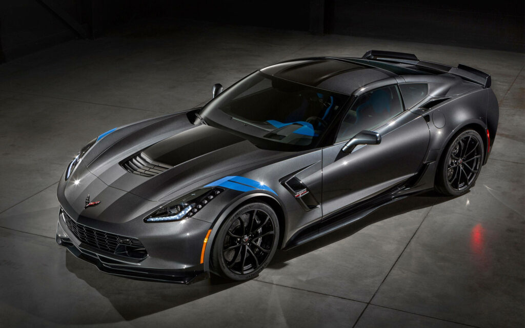 HD wallpaper of sleek metallic gray sport car with aerodynamic design in modern garage lighting