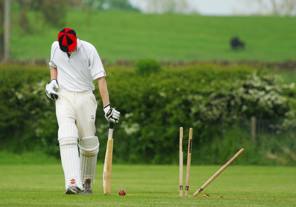 4K Cricket Wallpaper: Player in White Uniform in Serene Setting