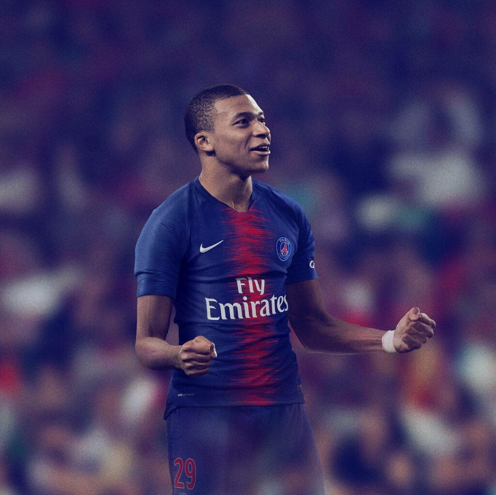 4K Kylian Mbappé PSG Wallpaper: Celebration in Intense Background