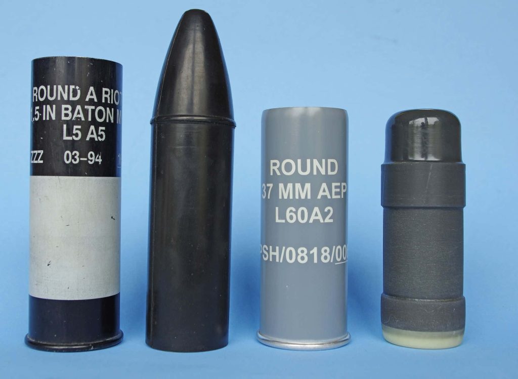 High-quality studio image of 1.5-inch baton round and 37mm AEP L60A2 riot control munitions on blue background Wallpaper