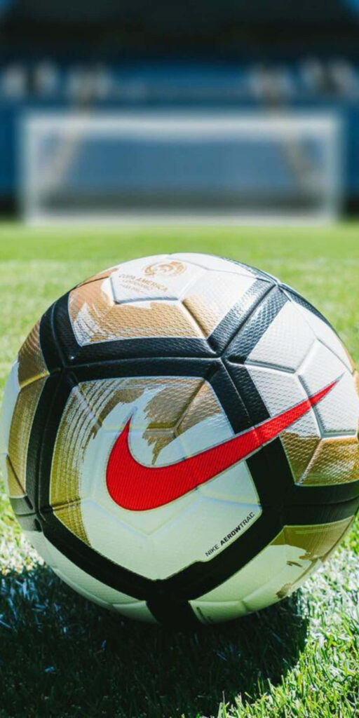 Stunning Soccer Ball Wallpaper with Red Nike Logo and Blurred Field
