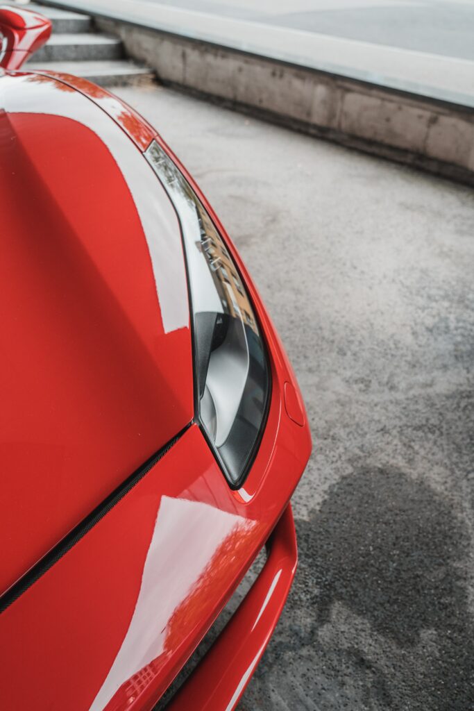 Stylish Red Car Aerial Wallpaper: Gleaming Design & Bold Color