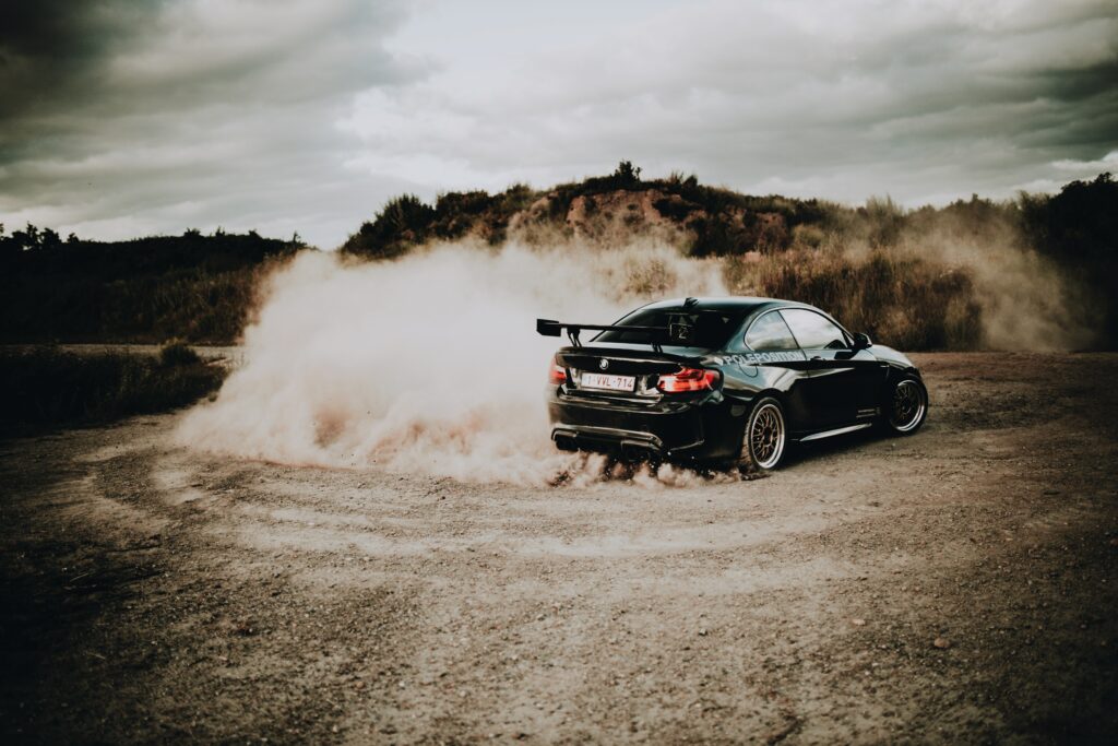 Dynamic Black BMW Drift Wallpaper: Rugged Terrain Adventure