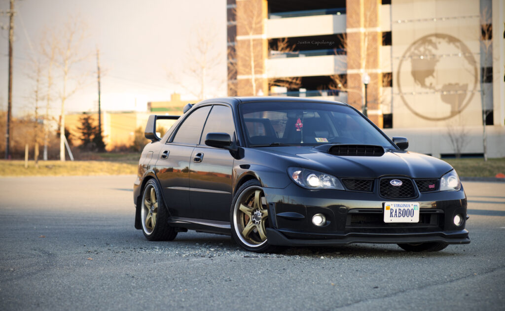 Sleek Black Subaru WRX Wallpaper: Sporty Design in Urban Setting