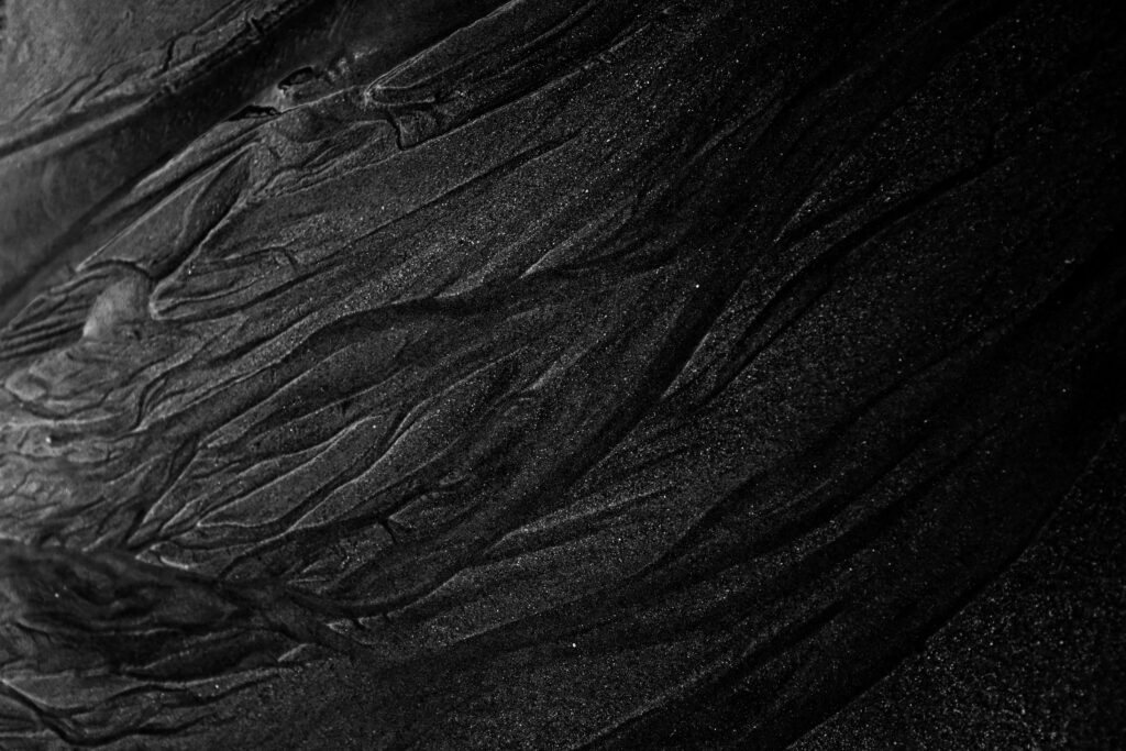 Intricate Black Textured Wallpaper Background with Dynamic Relief Pattern