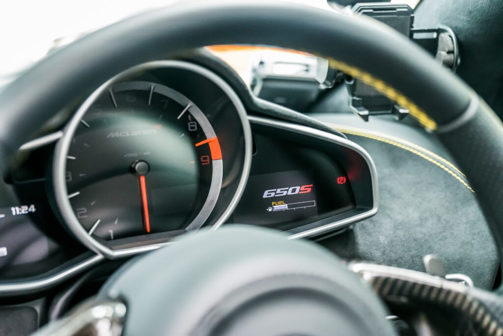 High-Res Car Interior Wallpaper: Speedometer & Steering Wheel Close-Up