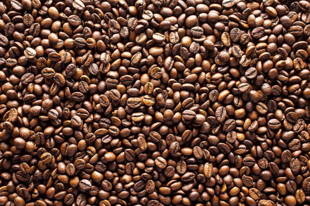 Top-down close-up of roasted coffee beans in warm mahogany and espresso brown tones wallpaper