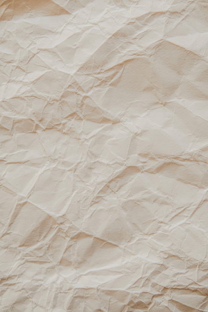 High-resolution crumpled paper wallpaper with soft cream folds minimalist textured background