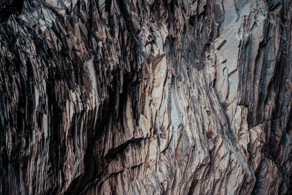 Dark Rugged Rock Formations: High-Resolution Wallpaper Background
