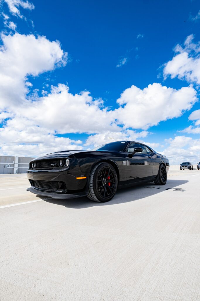 Vibrant Blue Sky & Sleek Black Dodge Challenger SRT Wallpaper