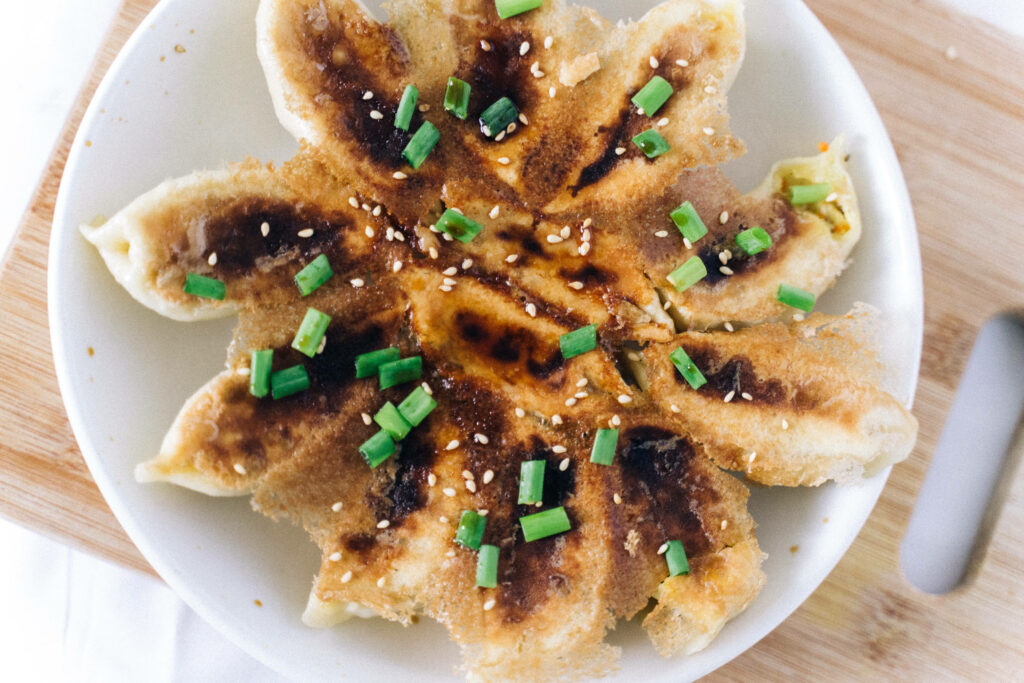 Appetizing Fried Dumplings Wallpaper with Green Onions & Sesame Seeds