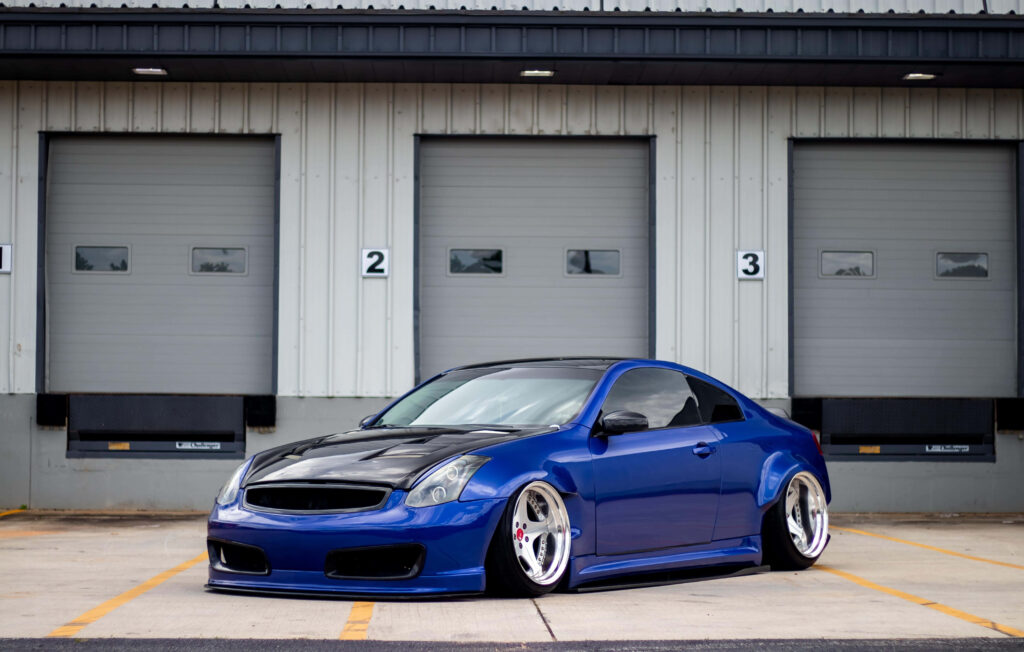 Modified Infiniti G35 Wallpaper: Blue, Bold Design in Garage Setting
