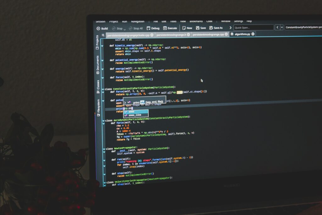 Colorful Coding Wallpaper: Laptop Screen & Dark Background Design