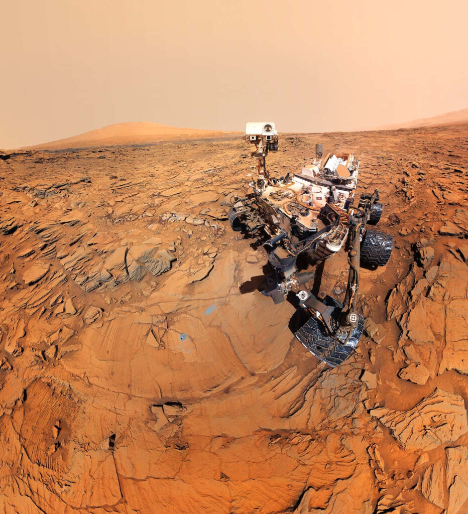 Robotic Rover on Mars: High-Res Wallpaper of Red Rocky Landscape