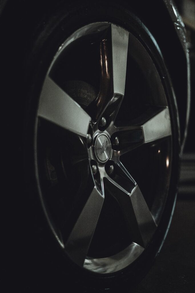 Close-Up of Sleek Metallic Car Wheel – High-Res Wallpaper