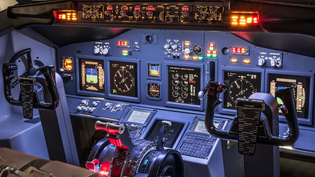 Nighttime airplane cockpit with vibrant illuminated instruments and advanced aviation technology view Wallpaper