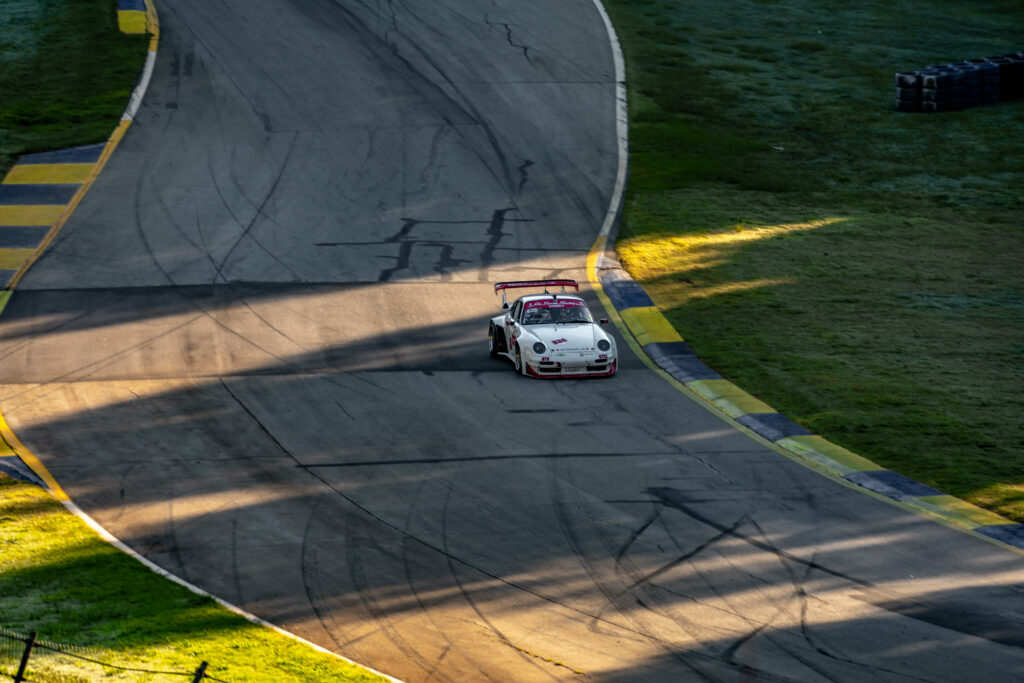 High-Res White Racing Car Wallpaper: Dynamic Motorsport Action