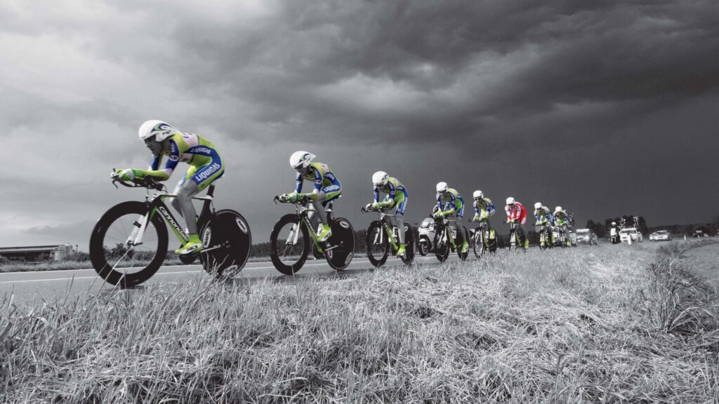 Vibrant Cyclists Racing: High-Res Sports Wallpaper Background