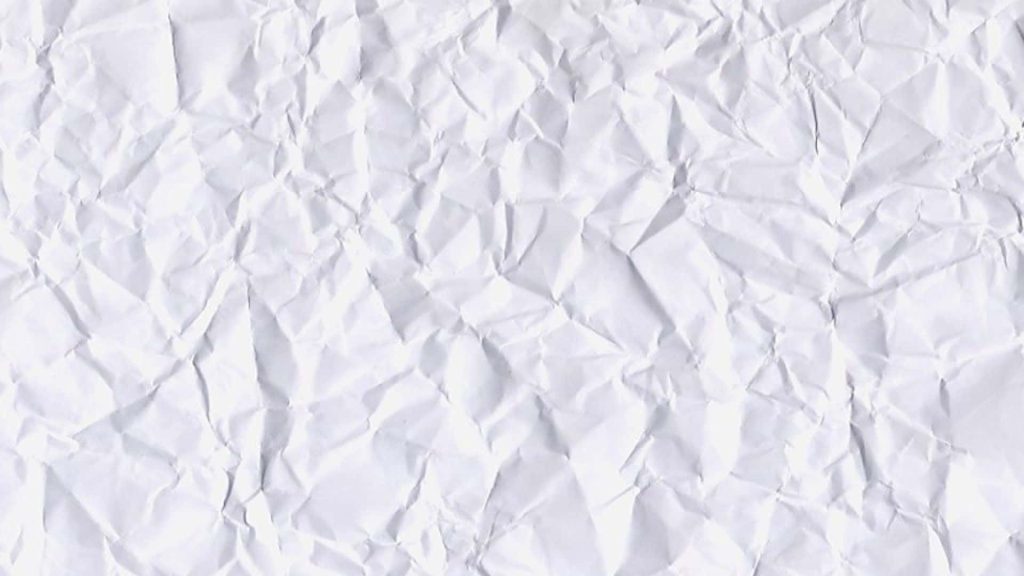 High-resolution white crumpled paper wallpaper with intricate folds and soft natural shadows