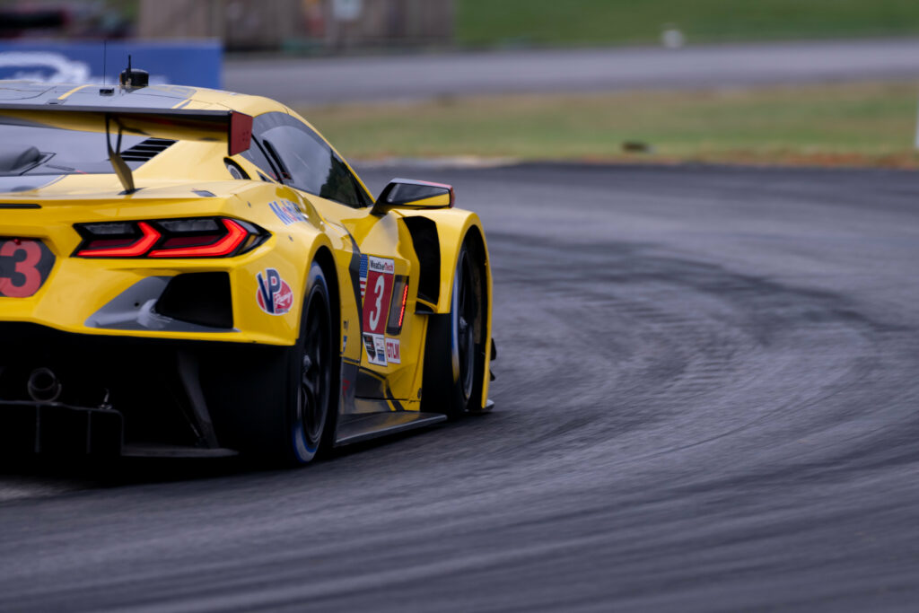 Vibrant Yellow Sports Car Racing on Winding Track - High-Res Wallpaper