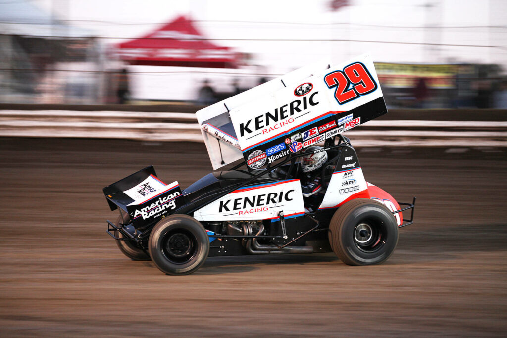High-speed dirt race car number 29 kicking up dust in intense competitive racing action scene Wallpaper