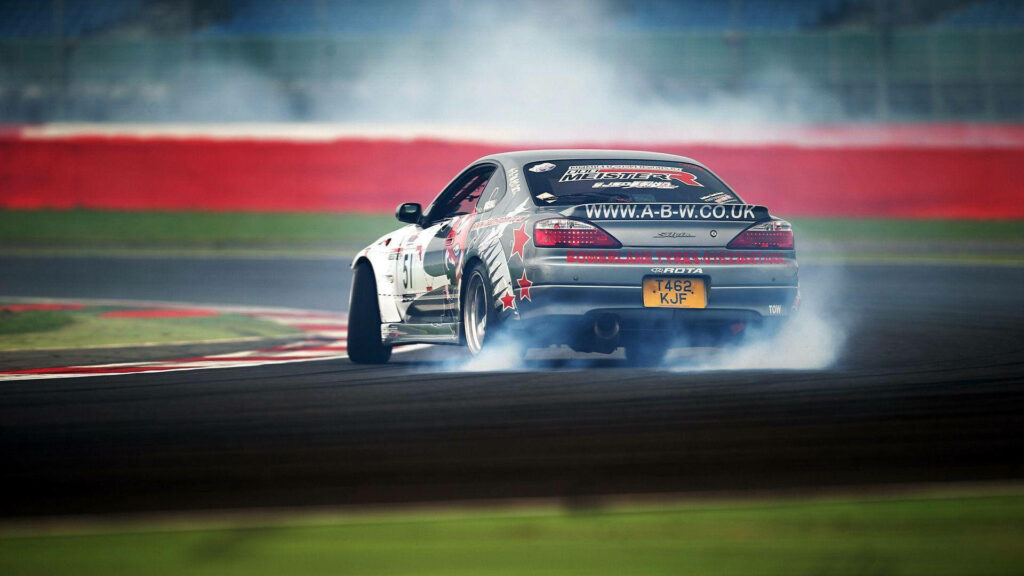 Drift car speeding on wet track kicking up smoke and water in thrilling motorsport action wallpaper