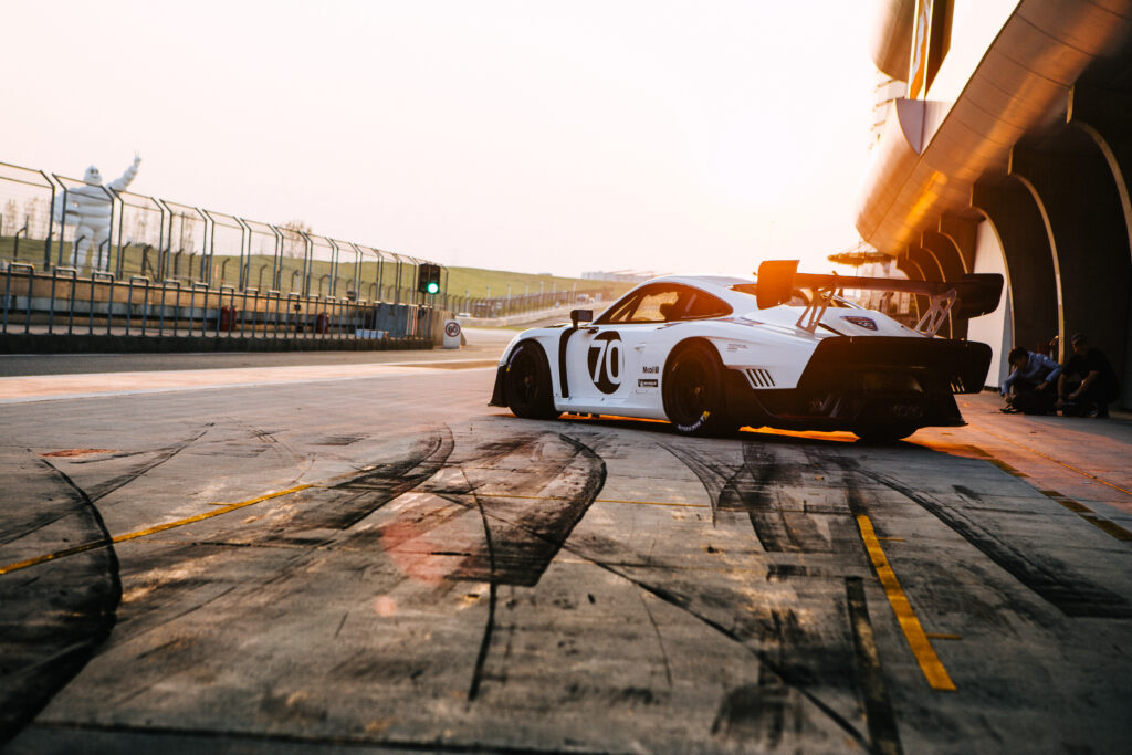 Porsche 935 Racing Wallpaper: Sunset Action on the Racetrack