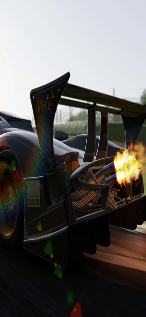 High speed racing car with bright flames from exhaust speeding on track motorsport action wallpaper