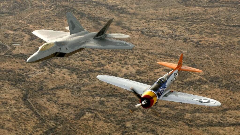 Dynamic Duo: Majestic F-22A Raptor and P-47 Thunderbolt Jets Soar Through Abandoned Terrain Wallpaper