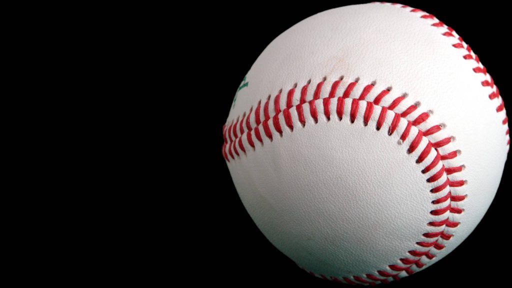 Close-up of classic baseball with red stitching on black background perfect sports wallpaper